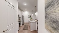 Located at 20 Calm Water Dr in Asheville, NC, this well-appointed 2-bedroom, 2-bathroom residence offers a thoughtfully designed single-floor layout. The open-concept kitchen and living area serves as the heart of the home, featuring white shaker cabinetry, granite countertops, a subway tile backsplash, stainless steel appliances, and a central island with pendant lighting — ideal for both cooking and casual dining. Wood-style flooring runs throughout, complementing the bright, neutral palette.

The living room is generously sized with large windows that invite natural light and offer views of the surrounding wooded landscape, along with direct access to an outdoor area. Both bedrooms are comfortably proportioned, each with ceiling fans, ample natural light, and access to dedicated closets featuring wire shelving systems for organized storage.

The primary bathroom offers a granite-topped double vanity, a walk-in shower, and direct access to a spacious walk-in closet. The secondary bathroom is clean and functional, complete with a tub-shower combination and brushed nickel fixtures. A hallway connects the rooms efficiently, completing this well-organized and modern residence in the heart of Asheville.