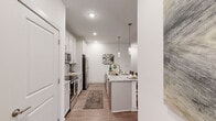 Located at 20 Calm Water Dr in Asheville, NC, this well-appointed 2-bedroom, 2-bathroom residence offers a thoughtfully designed single-floor layout. The open-concept kitchen and living area serves as the heart of the home, featuring white shaker cabinetry, granite countertops, a subway tile backsplash, stainless steel appliances, and a central island with pendant lighting — ideal for both cooking and casual dining. Wood-style flooring runs throughout, complementing the bright, neutral palette.

The living room is generously sized with large windows that invite natural light and offer views of the surrounding wooded landscape, along with direct access to an outdoor area. Both bedrooms are comfortably proportioned, each with ceiling fans, ample natural light, and access to dedicated closets featuring wire shelving systems for organized storage.

The primary bathroom offers a granite-topped double vanity, a walk-in shower, and direct access to a spacious walk-in closet. The secondary bathroom is clean and functional, complete with a tub-shower combination and brushed nickel fixtures. A hallway connects the rooms efficiently, completing this well-organized and modern residence in the heart of Asheville.