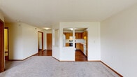 Located in White Bear Lake, Minnesota, this single-floor residence offers two bedrooms and three bathrooms in a well-organized layout. The kitchen is equipped with warm oak cabinetry, white countertops, a double basin sink, a dishwasher, a range, and a full-size refrigerator, all complemented by wood-look flooring that extends throughout the main living areas. Adjacent to the kitchen, the living room is carpeted and filled with natural light, featuring sliding glass doors that open to a private balcony overlooking a green outdoor setting. Both bedrooms are carpeted and generously sized, with large windows that frame pleasant outdoor views, creating bright and comfortable retreats. The primary bedroom offers a well-proportioned footprint with ample room for furnishings. The three bathrooms include a full bath with a vanity, wood-look flooring, and a tub-shower combination. A dedicated laundry room houses a full-size washer and dryer alongside wire shelving for added storage. Throughout the home, warm wood trim, textured ceilings, and neutral walls contribute to a clean, functional aesthetic suited to everyday living.