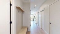 Located on East Colfax Avenue in Denver, CO, this efficiently designed single-floor unit offers a thoughtfully utilized layout with a bedroom and connecting hallway. The open kitchen is a standout feature, showcasing light wood cabinetry, a tiled backsplash, and a full suite of stainless steel appliances including a range, over-the-range microwave, dishwasher, refrigerator with ice maker, and a built-in wine cooler. A large window floods the kitchen and living area with abundant natural light and provides views of the surrounding neighborhood. Light-toned tile flooring runs throughout the main living space, lending a clean, contemporary aesthetic. The bedroom is a comfortable, well-lit retreat featuring a ceiling fan with integrated lighting, a window for additional natural light, and light hardwood-style flooring. Built-in open shelving in the hallway area provides convenient storage solutions. Neutral wall tones and clean white trim throughout the unit create a bright, cohesive atmosphere. This well-appointed space combines modern finishes with practical design, making it an efficient and stylish home in the heart of Denver.