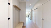 Located on East Colfax Avenue in Denver, CO, this efficiently designed single-floor unit offers a thoughtfully utilized layout with a bedroom and connecting hallway. The open kitchen is a standout feature, showcasing light wood cabinetry, a tiled backsplash, and a full suite of stainless steel appliances including a range, over-the-range microwave, dishwasher, refrigerator with ice maker, and a built-in wine cooler. A large window floods the kitchen and living area with abundant natural light and provides views of the surrounding neighborhood. Light-toned tile flooring runs throughout the main living space, lending a clean, contemporary aesthetic. The bedroom is a comfortable, well-lit retreat featuring a ceiling fan with integrated lighting, a window for additional natural light, and light hardwood-style flooring. Built-in open shelving in the hallway area provides convenient storage solutions. Neutral wall tones and clean white trim throughout the unit create a bright, cohesive atmosphere. This well-appointed space combines modern finishes with practical design, making it an efficient and stylish home in the heart of Denver.