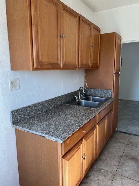 Kitchen with stove and refrigerator - 1321 W Martin Luther King Jr Blvd