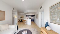 Located at 8485 Hammocks Blvd in Kendall West, FL, this single-floor, 2-bedroom, 2-bathroom residence offers a thoughtfully designed layout that maximizes both comfort and functionality. The open-concept main living area seamlessly integrates the living room, dining area, and kitchen into one bright, airy space finished with light tile flooring throughout. The kitchen is equipped with stainless steel appliances, dark espresso cabinetry with a subway tile backsplash, and a white quartz peninsula that doubles as a breakfast bar — ideal for casual dining or entertaining. A dedicated dining nook sits adjacent, providing an intimate setting for meals. The living room benefits from large sliding glass doors that invite natural light and offer outdoor views. The primary bedroom features wood-style flooring, a sun-filled window, and access to a generously sized walk-in closet with built-in shelving. Both bathrooms are finished with matching dark wood vanities, white countertops, and tile flooring. A dedicated in-unit laundry room houses a full-size washer and dryer. With six closets spread throughout, storage is plentiful. The clean, neutral palette and modern finishes create a cohesive and inviting ambiance throughout the home.
