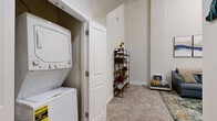 This one-bedroom, one-bathroom residence at 113-121 N 20th St in Richmond, VA offers a well-planned layout that maximizes every square foot. The living room serves as the centerpiece of the home, boasting impressively tall ceilings that lend a sense of openness well beyond its footprint. A striking fireplace framed in bold black marble tile with a classic white mantel anchors the room, creating a warm and inviting focal point. Neutral carpet and soft wall tones throughout complement the space's understated, modern aesthetic.

The kitchen features light maple cabinetry paired with dark granite countertops and white tile flooring, offering a clean, functional workspace equipped with full-size appliances. The open connection between the kitchen and living area promotes an easy flow for everyday living.

The bedroom is a comfortable, well-proportioned retreat finished with plush carpeting and neutral walls, providing a calm and restful atmosphere. The full bathroom continues the consistent design language of the home, featuring tile flooring, a tub/shower combination, a light wood vanity with a dark stone countertop, and clean white fixtures throughout. This residence delivers a practical, cohesive living experience in the heart of Richmond.