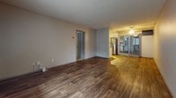 This 630 square foot apartment offers a practical and efficient living space. The unit features two bedrooms, including a primary bedroom of 160 square feet, and one bathroom. The single-floor layout maximizes the use of available space.

The interior boasts modern finishes throughout. Rich, wood-look flooring extends through the main living areas and bathroom, creating a warm and cohesive appearance. The bedrooms are carpeted for added comfort. Neutral-toned walls provide a clean backdrop, allowing for personalized decor.

The bathroom showcases contemporary fixtures, including a white vanity with a granite countertop and a standard toilet. Wood-look flooring in the bathroom adds a touch of elegance.

The living room is bright and airy, with a large window allowing natural light to flood the space. The open-concept design likely incorporates a dining area and leads to the kitchen, which appears to have white cabinetry and modern appliances.

Storage is addressed with a dedicated closet space, featuring built-in shelving and hanging rods. The apartment's compact size is ideal for singles or couples seeking an efficient living space in an urban setting.