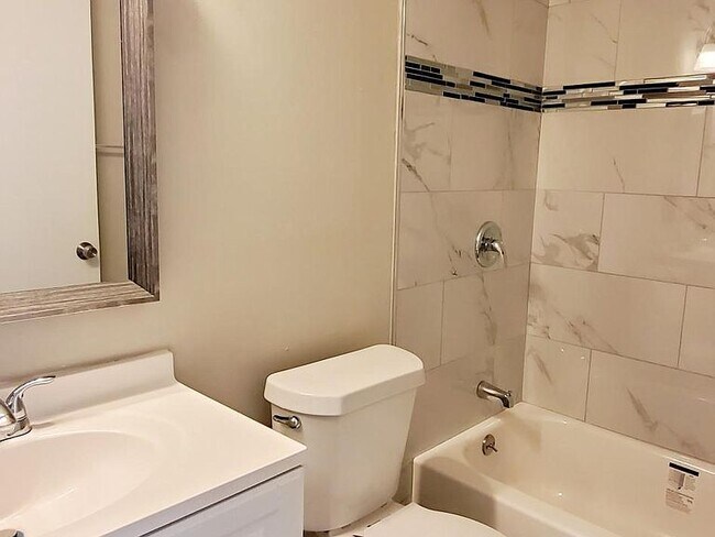 Guest bathroom with brand new shower tile and bathtub. - 1300 Bay Hill Blvd.