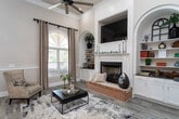 Located at 9000 Grandeur Dr in Salisbury, NC, this impressive single-story community facility seamlessly blends upscale design with versatile recreational amenities. The grand entrance foyer sets the tone immediately, showcasing soaring ceilings, stately white columns, detailed crown molding, and light gray wood-look flooring that flows throughout the space. Arched windows flood the entry corridor with natural light, leading visitors past an elegant chandelier and double French doors.

The lounge area exudes sophistication with high ceilings, navy wainscoting with inset paneling, large arched windows, and a statement chandelier. A fitness center offers a bright, welcoming environment with oversized arched windows overlooking outdoor greenery and an array of cardio equipment. The kitchen is well-equipped with crisp white cabinetry, dark granite countertops, and stainless steel appliances, ideal for catering and events.

A highlight of the facility is the expansive gymnasium, featuring a full basketball court with painted court lines, high ceilings with recessed lighting, and tiered aluminum bleachers along the perimeter. Additional utility areas with painted concrete block construction provide functional support space. The overall design balances refined aesthetics in the clubhouse with the practical demands of an active community hub.