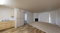 Located at 30 Castlewood Drive in Pittsburg, CA, this 2-bedroom, 1-bathroom single-floor home offers a practical and comfortable layout. The open-concept kitchen and living area serves as the heart of the home, featuring wood-style hard flooring that transitions seamlessly between spaces. The kitchen is well-equipped with light wood cabinetry, white appliances including a refrigerator, electric range, built-in microwave, and dishwasher, along with ample counter space and overhead lighting. The living room is a welcoming space anchored by a gas fireplace and features plush carpeting, a sliding door with vertical blinds that allows natural light to filter in. A hallway connects the main living area to the two bedrooms and bathroom. The primary bedroom is generously sized and includes a walk-in closet with built-in shelving for organized storage. The second bedroom features carpet flooring and a window with a pleasant view of surrounding greenery. The full bathroom is finished with wood-style flooring, a single-sink vanity with light wood cabinetry, a large mirror, and a shower. A dedicated closet provides additional storage within the unit. The neutral color palette and consistent finishes throughout lend the home a clean, cohesive feel.