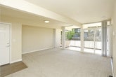 This single-floor residence offers a thoughtfully designed layout with a neutral color palette and a mix of flooring materials throughout. The kitchen is equipped with white shaker-style cabinetry, granite-look countertops, and a full suite of stainless steel appliances, including a gas range, built-in microwave, and refrigerator. A double sink with under-cabinet lighting adds functionality, while wood-look plank flooring ties the space together.

The living area is generously proportioned, featuring plush wall-to-wall carpeting and large sliding glass doors that open to a private balcony with outdoor views of surrounding greenery. A dedicated entryway with hard-surface flooring transitions smoothly into the carpeted living space, providing a practical entry point.

The bedrooms are carpeted and finished with neutral walls, offering a calm and comfortable atmosphere. Each room includes mirrored sliding-door closets with built-in shelving for organized storage. An additional closet with multi-tier shelving provides supplemental storage options.

The bathroom is clean and functional, featuring a white vanity with a sink, a mirrored medicine cabinet, and wood-look flooring that coordinates with other hard-surface areas in the unit. The overall ambiance is bright, well-maintained, and move-in ready.