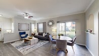 Located at 11245 West Rd in Houston, TX, this single-story, 2-bedroom, 2-bathroom home offers a thoughtfully designed layout that maximizes comfort and functionality. The open-concept living and dining area is anchored by wood-look flooring, crown molding, and a ceiling fan, with large sliding glass doors that flood the space with natural light and provide views of the outdoor greenery. Elegant arched doorways connect the living area to the kitchen, which features rich dark wood cabinetry, granite-look countertops, a white subway tile backsplash, and stainless steel appliances. The dedicated laundry room includes overhead cabinetry for added storage. The spacious primary bedroom is carpeted and accented with a ceiling fan and a generous walk-in closet fitted with wire shelving systems. Both bathrooms mirror the kitchen's design aesthetic, showcasing dark wood vanities, granite-style countertops, and tub-shower combinations. The attached garage is equipped with an automatic opener and provides additional utility space. Neutral tones, consistent finishes, and an efficient single-floor plan make this Houston home a practical and comfortable residence.