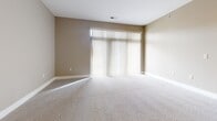 This contemporary 780 square foot apartment in Omaha, NE offers a well-designed living space with one bedroom and one bathroom. The open floor plan seamlessly integrates the kitchen, living, and dining areas, creating a spacious feel. The kitchen boasts rich wood cabinetry, sleek black countertops, and modern stainless steel appliances, including a side-by-side refrigerator and built-in microwave. 

The primary bedroom, measuring 170 square feet, features plush carpeting and large windows with horizontal blinds, allowing for abundant natural light. A ceiling fan adds both style and functionality. The bathroom showcases a expansive vanity with ample storage and a large mirror. 

Throughout the apartment, neutral-toned walls and trim create a clean, fresh ambiance. Plush carpeting in the main living areas and bedroom provides comfort underfoot. Track lighting in the kitchen and a mixture of recessed and decorative lighting fixtures throughout add to the modern aesthetic. The apartment's layout includes a convenient hallway and closet space for additional storage.