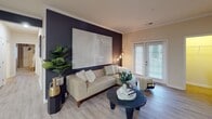 Located at Waterstone Park Circle in Hillsborough, NC, this thoughtfully designed single-floor residence offers a cohesive blend of modern finishes and warm, inviting details throughout. The open-concept living area serves as the heart of the home, anchored by a striking deep navy accent wall that provides a dramatic backdrop for the space. Crown molding adds a refined touch, while light wood-look flooring flows seamlessly underfoot. A set of glass-paned French doors allows natural light to pour in and provides access to the outdoors. The kitchen is well-equipped with rich warm-toned cabinetry, granite countertops, stainless steel appliances including a refrigerator, range, and microwave, and a peninsula with additional workspace and seating. The bedrooms continue the design language of the living spaces, each featuring the signature navy accent wall, plush carpeting, ceiling fans, and windows that invite natural light. The bathrooms are clean and functional, outfitted with warm wood vanities, white countertops, framed mirrors, and tub-shower combinations with crisp white surrounds. Light tile-look flooring and bright vanity lighting complete each bathroom's polished look. Overall, this residence offers a well-balanced living environment with consistent, contemporary style from room to room.