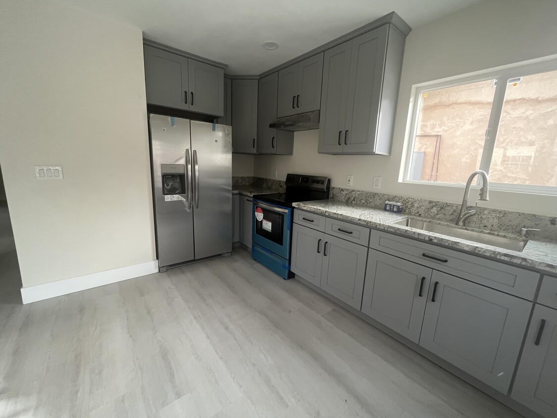 Open kitchen with BRAND new fridge, dishwasher, and stove - 6247 Agra St