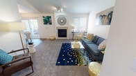 Located at 5407 117th Street Ct E in Puyallup, WA, this single-floor residence offers a thoughtfully designed layout with comfortable living spaces throughout. The living room serves as the heart of the home, highlighted by a built-in fireplace with an elegant arched surround, vaulted ceilings that enhance the sense of openness, and soft carpet underfoot. Natural light filters in through multiple windows, creating a bright and welcoming atmosphere. The dining area connects seamlessly to a private balcony via sliding glass doors, providing pleasant outdoor views of the surrounding neighborhood — an ideal spot for morning coffee or evening relaxation. The kitchen features warm wood-toned cabinetry, white appliances including an electric range and dishwasher, wood-look flooring, and ample counter space for everyday cooking. The residence includes two well-proportioned bedrooms, each carpeted and equipped with closets and windows that bring in natural light. The full bathroom is finished with wood-look flooring, a single-sink vanity with wood cabinetry, a white countertop, and a shower-tub combination. Overall, the space presents a clean, neutral palette with functional design elements that make it a comfortable and practical home.