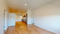 Located at 14378 Walnut Grove Way in Oregon City, Oregon, this thoughtfully designed two-bedroom, two-bathroom residence offers a clean, modern aesthetic across a single floor. Warm hardwood-style flooring flows throughout the entire space, lending a cohesive and inviting feel to every room.

The kitchen is a standout feature, showcasing contemporary wood-toned cabinetry with sleek hardware, crisp white quartz countertops, and a full suite of stainless steel appliances including a refrigerator, electric range, built-in microwave, and dishwasher. Open shelving adds both function and visual interest to the space.

The open living area is bright and airy, benefiting from large windows that bring in natural light and offer views of the surrounding neighborhood's mature trees. The primary bedroom is generously sized and includes a dedicated walk-in closet with built-in wire shelving. The second bedroom is equally well-lit with an outward-facing window.

Both bathrooms are finished in a clean, modern style. One features a full tub/shower combo with chrome fixtures, while the other includes a wood-toned vanity with a white quartz countertop and a large mirror. A stacked washer/dryer unit is also included within the residence for added convenience.