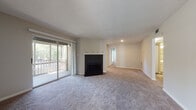 Located at 2225 Ashley River Road in Charleston, SC, this single-floor residence offers a well-organized layout with comfortable living spaces throughout. The open living area serves as the heart of the home, centered around a striking black-tiled fireplace with a crisp white mantel. Sliding glass doors fill the room with natural light and provide direct access to a private balcony overlooking lush, tree-lined surroundings. Plush carpet flooring and a textured ceiling complete the relaxed, comfortable atmosphere.

The kitchen is outfitted with white shaker-style cabinetry, granite-look countertops, wood-look flooring, and black appliances including a refrigerator, dishwasher, and range. A window above the sink brings in additional natural light, making the space bright and functional.

The bedrooms are carpeted and generously sized, each featuring ceiling fans with light fixtures and ample natural light from windows with blinds. One bedroom includes a sliding glass door to a secondary outdoor access point, adding versatility to the space.

Both bathrooms are finished with wood-look flooring, white vanities, and tub-shower combinations. The neutral color palette and clean finishes found throughout the home create a cohesive, move-in-ready aesthetic ideal for comfortable Charleston living.
