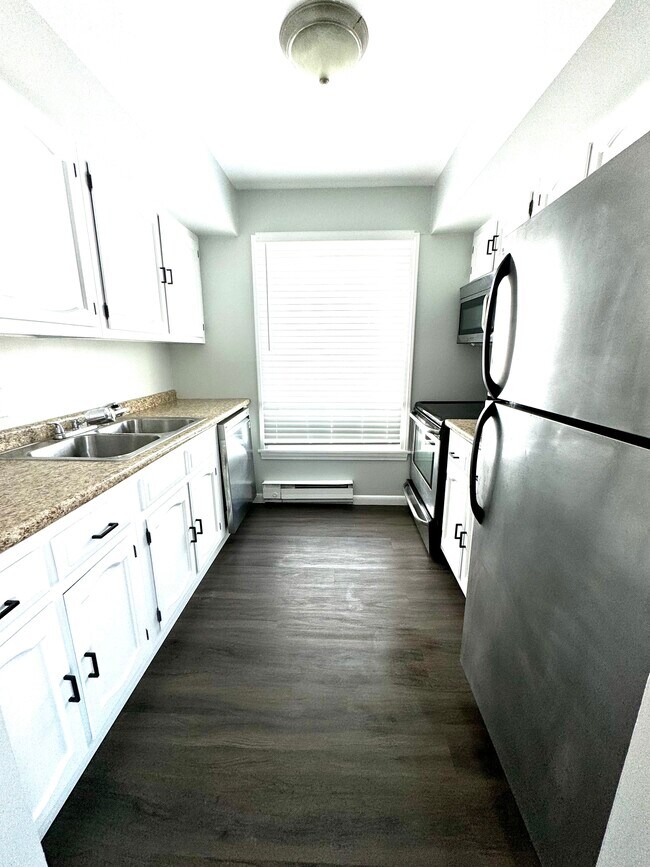 Kitchen with stainless steel appliances. (Quartz countertops to be installed.) - 288 Main St