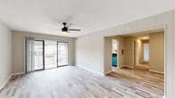 Located at 1505 Chatham Ct in Virginia Beach, Virginia, this single-floor residence offers a thoughtfully updated interior with a clean, modern aesthetic. The open living area features light-toned hardwood-style flooring, a ceiling fan with integrated lighting, and a shiplap accent wall that adds a contemporary design touch. Sliding glass doors lead directly to a private balcony, filling the space with natural light and providing outdoor views of the surrounding neighborhood.

The kitchen is well-equipped with white shaker cabinetry, dark granite countertops, and a full suite of stainless steel appliances, including a gas range, microwave, and refrigerator. Wood-look tile flooring and a tray ceiling detail complete the functional yet stylish kitchen space.

The bedrooms are carpeted for comfort and feature large windows that invite ample natural light. At least one bedroom includes an en-suite bathroom and a dedicated closet, while an additional bedroom offers a standard closet with double doors. The bathrooms are finished with dark granite vanity tops, white cabinetry, and wood-look tile flooring, maintaining a consistent design language throughout the home. The overall ambiance is bright, neutral, and move-in ready.