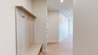 Located on East Colfax Avenue in Denver's vibrant Congress Park neighborhood, this modern 2-bedroom, 3-bathroom residence offers a well-designed open-concept layout with contemporary finishes throughout. Light wood-style flooring flows seamlessly across the entire floor, complementing the clean, neutral color palette.

The kitchen is a standout feature, showcasing a large white quartz waterfall island with an undermount sink, light wood cabinetry extending to the ceiling, a textured tile backsplash, and stainless steel appliances including a French door refrigerator and range. Pendant lighting adds a refined touch above the island.

The living area is bathed in natural light through expansive floor-to-ceiling windows and sliding glass doors that open to a balcony, offering elevated views of the surrounding Denver streetscape and tree canopy. Ceiling fans are present in the main living spaces.

Both bedrooms are generously sized, with large windows framing urban views. The primary bedroom features sliding glass doors to the balcony and a dedicated closet. Each of the three bathrooms is finished with a clean modern aesthetic — one featuring large-format gray tile surrounding a soaking tub, and another with a dual-sink vanity topped in white quartz with light wood cabinetry. Two additional closets provide ample storage throughout.
