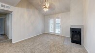 Located at 7414 E Grand Ave in Dallas, TX, this two-bedroom, one-bathroom unit offers a well-designed single-level layout. The living room is anchored by soaring vaulted ceilings, a ceiling fan light fixture, a cozy fireplace, and French doors that open to a private patio, allowing natural light to fill the space. Plush carpet flows throughout the living and bedroom areas, while wood-look flooring defines the kitchen and dining zones.

The open-concept kitchen and dining area is thoughtfully appointed with dark espresso cabinetry, a subway tile backsplash, granite countertops extending into a peninsula with an undermount sink, and a full suite of stainless steel appliances. A stylish chandelier overhead adds an elegant touch to the dining space.

The primary bedroom is generously sized and features access to a walk-in closet with built-in shelving. The second bedroom offers comfortable proportions with its own closet. Additional storage is provided through multiple closets and a pantry throughout the unit. A dedicated laundry area adds everyday convenience.

The bathroom is finished with granite countertops, dark wood cabinetry with brushed nickel hardware, wood-look tile flooring, and a tiled tub-shower combo. A hallway connects the main living areas to the private bedroom wing, completing this functional and stylish layout.