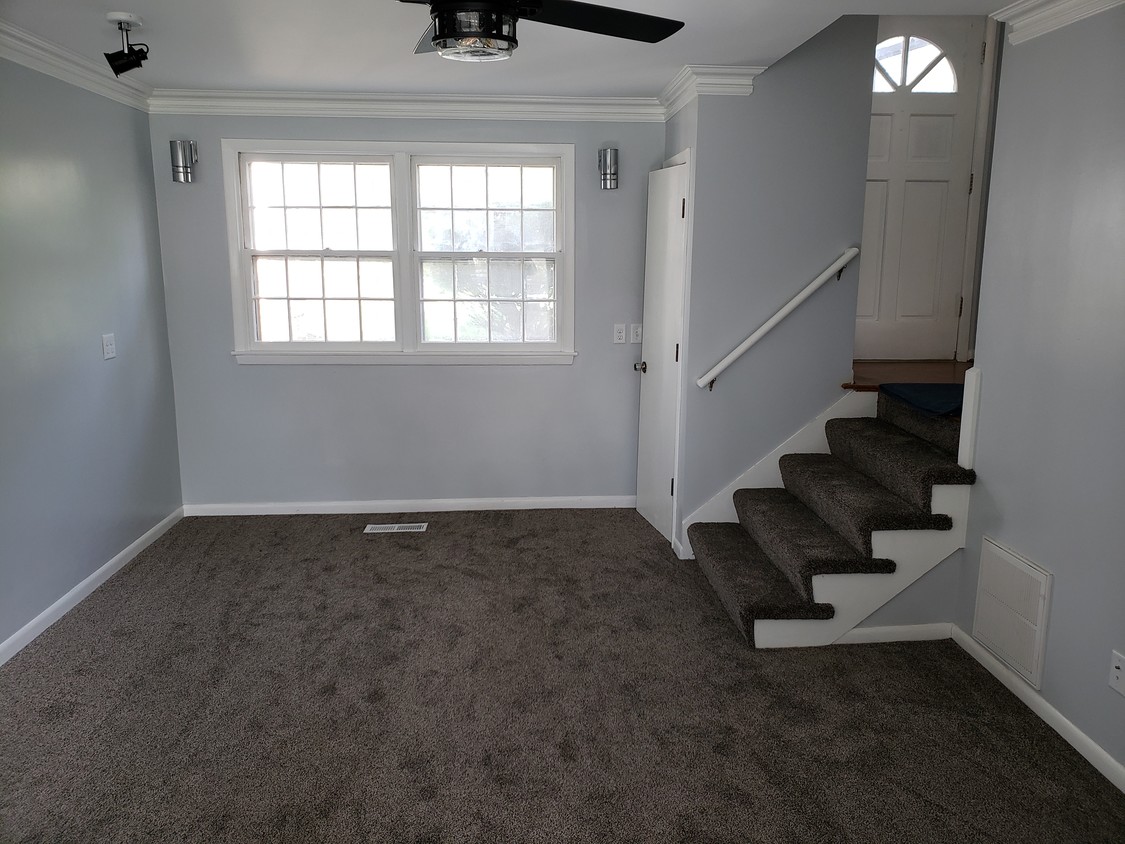 Nice living room with new carpet, sconces,fan - 6452 Washington Ave
