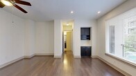 Located at 3521 Wilshire Way in Richardson, TX, this well-designed one-bedroom, two-bathroom residence offers a functional and modern living experience across a single floor. Rich, dark hardwood flooring flows throughout the main living areas, creating a warm and cohesive aesthetic complemented by clean white walls and recessed lighting.

The open-concept kitchen and living area serves as the heart of the home. The kitchen is equipped with dark espresso cabinetry, stainless steel appliances including a French door refrigerator and microwave, a tile backsplash, and a sleek white peninsula countertop with pendant lighting overhead — ideal for casual dining or entertaining. A built-in niche with cabinetry and a wine rack adds a distinctive design touch to the living area.

Large windows allow natural light to fill the space, while a ceiling fan provides added comfort. The hallways are well-lit and connect seamlessly to the bedroom, closets, and bathrooms.

The primary bedroom features plush carpet flooring, a ceiling fan, and access to a spacious en-suite bathroom complete with a dual-sink vanity featuring dark cabinetry and stone countertops. A second bathroom includes a soaking tub with tile surround and a built-in niche. Two generous walk-in closets with built-in shelving provide ample storage throughout the home.