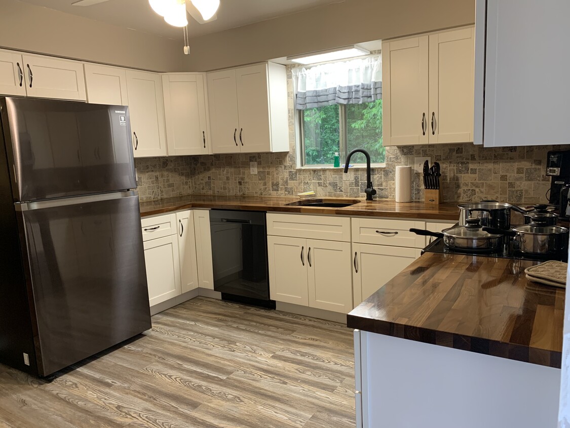 New Kitchen with New cabinets and black stainless appliances and European walnut butcher block tops - 5136 Old Lemay Ferry Rd