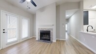 This contemporary 850 square foot apartment offers a well-designed living space with two bedrooms and two full bathrooms. The open-concept floor plan maximizes the use of space, creating a seamless flow between the living areas. The kitchen showcases modern gray cabinetry, sleek black appliances, and a white subway tile backsplash, complemented by a practical island with a built-in sink.

Throughout the apartment, wood-look flooring adds warmth and durability. The bathrooms feature clean, white fixtures and tub/shower combinations, with one bathroom boasting a gray vanity for added style. Both bedrooms are generously sized, with the primary bedroom measuring 150 square feet and including a closet for storage.

The living room is a highlight, featuring a cozy fireplace with a stone surround and large windows that flood the space with natural light. Ceiling fans in select rooms provide additional comfort. The neutral color palette of light gray walls and white trim creates a bright, airy atmosphere that's perfect for personalizing.

Located at 3750 Carothers Pkwy in Franklin, TN, this single-story apartment combines modern amenities with a practical layout, ideal for comfortable living in a prime location.