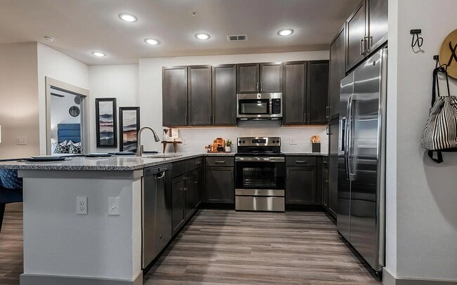 U-Shaped Kitchen with Dark Cabinetry and Granite Countertops - The Harper