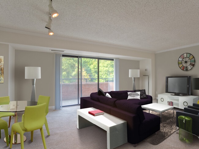 Living and dining areas with balcony access and carpeted flooring - Avalon at Foxhall Apartments