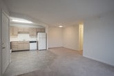 This single-floor residence at 100 Marshview Dr in Newport News, Virginia offers a practical and well-organized layout designed for comfortable everyday living. The open-concept living and dining area features neutral-toned carpet and transitions seamlessly into the kitchen via a pass-through opening. A sliding glass door with vertical blinds fills the living space with natural light and provides access to the outdoors.

The kitchen is equipped with light wood cabinetry, an electric range with overhead ventilation, a dishwasher, refrigerator, and a double sink. Tile flooring runs throughout the kitchen, and a dedicated pantry with wire shelving offers generous storage.

The bedrooms are carpeted and bright, with multiple windows that invite natural light and offer views of the surrounding greenery. The primary bedroom includes two closets — one with a rod and one with built-in shelving — providing ample storage. Additional bedrooms are well-sized with clean, neutral walls.

Both bathrooms feature tile flooring, light wood vanities with white countertops, and tub-shower combinations with chrome fixtures. The layout is efficient, with each bathroom neatly appointed for functionality. Overall, the residence presents a clean, neutral palette throughout, making it a versatile and move-in ready space.