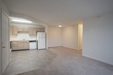This single-floor residence at 100 Marshview Dr in Newport News, Virginia offers a practical and well-organized layout designed for comfortable everyday living. The open-concept living and dining area features neutral-toned carpet and transitions seamlessly into the kitchen via a pass-through opening. A sliding glass door with vertical blinds fills the living space with natural light and provides access to the outdoors.

The kitchen is equipped with light wood cabinetry, an electric range with overhead ventilation, a dishwasher, refrigerator, and a double sink. Tile flooring runs throughout the kitchen, and a dedicated pantry with wire shelving offers generous storage.

The bedrooms are carpeted and bright, with multiple windows that invite natural light and offer views of the surrounding greenery. The primary bedroom includes two closets — one with a rod and one with built-in shelving — providing ample storage. Additional bedrooms are well-sized with clean, neutral walls.

Both bathrooms feature tile flooring, light wood vanities with white countertops, and tub-shower combinations with chrome fixtures. The layout is efficient, with each bathroom neatly appointed for functionality. Overall, the residence presents a clean, neutral palette throughout, making it a versatile and move-in ready space.