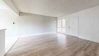 This single-story, 2-bedroom, 1-bathroom unit at 627 S Velare St in Anaheim, California offers a practical and well-organized layout. The living room is a welcoming, open space finished with light wood-style laminate flooring and neutral white walls, with a large window and front entry door allowing natural light to fill the room. A pass-through opening connects the living area to the kitchen, enhancing the sense of openness between the two spaces.

The kitchen is efficiently designed with white cabinetry, light countertops, a stainless steel dishwasher, a gas range, and a striking mosaic tile backsplash in earthy tones. Track lighting overhead provides ample illumination, and tile flooring adds durability to the space.

Both bedrooms feature plush carpeting and bright windows fitted with vertical blinds that filter natural light. The spacious primary bedroom includes a sliding double-door closet, offering generous storage. The second bedroom, though more compact, maintains the same clean, neutral aesthetic.

The bathroom is finished with tile flooring, a tub-shower combination, built-in shelving, and overhead cabinetry, providing functional storage. A textured ceiling is consistent throughout the unit, contributing to its classic residential character.
