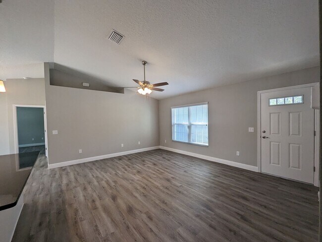 Building Photo - New 3/2/2 fenced home with Many Upgrades i...