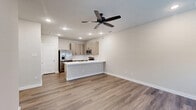Located at 1340 County Road 1106 in Anna, TX, this well-appointed single-story, one-bedroom, one-bathroom home offers a thoughtfully designed layout that maximizes every inch of its footprint. The open-concept kitchen and living area serves as the heart of the home, featuring warm wood-look luxury vinyl plank flooring, recessed lighting, and a ceiling fan that enhances the bright, airy atmosphere. The kitchen is outfitted with light-toned cabinetry, a classic white subway tile backsplash, stainless steel appliances including a refrigerator with ice maker, range, microwave, and dishwasher, as well as a white quartz peninsula countertop with an undermount sink — ideal for both meal prep and casual dining. A dedicated pantry provides additional storage. The living area is open and inviting, with natural light filtering in through the front entrance windows. The spacious primary bedroom includes a ceiling fan, a closet, and direct access to the bathroom and laundry area. The bathroom features wood-look tile flooring, a modern vanity, and a frameless glass walk-in shower adorned with white subway tile. An entrance area and dedicated laundry space round out this clean, modern home.