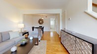Located at 900 Pump Rd in Henrico, Virginia, this two-floor residence offers a thoughtfully designed layout that balances comfort and functionality. Warm hardwood flooring flows throughout the main living areas, lending a cohesive and inviting character to the space.

The living room is bright and open, with neutral walls that allow natural light to fill the room. It connects seamlessly to a dedicated dining area, complete with a stylish pendant light fixture and ample space for entertaining. A decorative credenza and curated artwork add refined touches throughout.

The kitchen is well-equipped, featuring rich dark cabinetry, granite-style countertops, stainless steel appliances including a refrigerator and dishwasher, and light tile flooring. It is both practical and visually appealing.

The residence includes multiple bedrooms, each finished with the same warm hardwood flooring and neutral tones that define the rest of the home. Bedrooms are comfortably sized, with natural light provided by windows fitted with blinds.

The bathroom is finished in clean white subway tile, with a full tub-shower combination and tile flooring, maintaining a crisp and functional aesthetic. The staircase connects both floors, with the upper level offering additional bedroom space as seen in the Matterport dollhouse view.