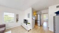Located at 6238 SW 59th Pl in South Miami, FL, this 2-bedroom, 1-bathroom single-floor residence offers a clean, modern aesthetic defined by crisp white walls, light wood-style flooring, and an abundance of natural light from windows throughout. The open-concept living area flows seamlessly into the kitchen, creating a cohesive and functional common space. The living room features multiple windows with views of surrounding greenery, providing a bright and welcoming atmosphere. The kitchen is well-appointed with gray shaker-style cabinetry, white countertops, a herringbone tile backsplash, stainless steel appliances including a French door refrigerator and range, and a window that brings in additional natural light. Both bedrooms are comfortably sized, featuring light-filled windows with outdoor views, light wood flooring, and clean white walls that create a calm, restful environment. The primary bedroom includes a frosted glass door that connects to additional space. The bathroom is finished with large-format white wall tiles, a walk-in shower with marble mosaic tile flooring, a modern vanity with a white countertop, and a bright overhead light fixture. This home offers a cohesive, minimalist design throughout.