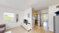 Located at 6238 SW 59th Pl in South Miami, FL, this 2-bedroom, 1-bathroom single-floor residence offers a clean, modern aesthetic defined by crisp white walls, light wood-style flooring, and an abundance of natural light from windows throughout. The open-concept living area flows seamlessly into the kitchen, creating a cohesive and functional common space. The living room features multiple windows with views of surrounding greenery, providing a bright and welcoming atmosphere. The kitchen is well-appointed with gray shaker-style cabinetry, white countertops, a herringbone tile backsplash, stainless steel appliances including a French door refrigerator and range, and a window that brings in additional natural light. Both bedrooms are comfortably sized, featuring light-filled windows with outdoor views, light wood flooring, and clean white walls that create a calm, restful environment. The primary bedroom includes a frosted glass door that connects to additional space. The bathroom is finished with large-format white wall tiles, a walk-in shower with marble mosaic tile flooring, a modern vanity with a white countertop, and a bright overhead light fixture. This home offers a cohesive, minimalist design throughout.