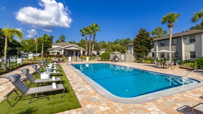 Immerse yourself in the newly renovated resort-style pool, surrounded by ample lounge seating for basking in the Florida sunshine. - Ridgemar Commons