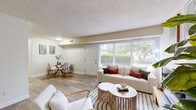 Located at 2018 Cunningham Dr in Hampton, VA, this well-appointed 2-bedroom, 1-bathroom single-floor residence offers a comfortable and functional layout. The inviting living room features warm wood-look flooring, a textured ceiling, and large windows that fill the space with natural light and provide views of the surrounding greenery. A welcoming entryway with hardwood-style flooring leads seamlessly into the living and dining areas, creating a cohesive, open feel throughout.

The kitchen is well-equipped with rich dark wood cabinetry, granite-style countertops, a classic subway tile backsplash, and a full suite of stainless steel appliances including a gas range, dishwasher, and full-size refrigerator. Light tile flooring and ample cabinet storage make this a highly functional cooking space. A dedicated laundry area adds everyday convenience.

Both bedrooms feature plush carpeting and generous windows overlooking outdoor green spaces. The spacious primary bedroom offers notable room for furnishings, while the second bedroom provides a cozy, well-lit retreat. Four closets throughout the unit ensure excellent storage capacity. The bathroom features clean white tile with a decorative accent border, a tub-shower combination, and a dark wood vanity with granite-style countertop, completing this tidy and comfortable home.