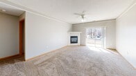 Located at 2901 Fletcher Ave in Lincoln, Nebraska, this single-floor, 2-bedroom, 2-bathroom home offers a practical and well-organized layout. The open living area is finished with neutral-toned carpet and features a ceiling fan with light fixture, making it a comfortable central gathering space. Crown molding adds a clean, finished look to the living room, which flows openly toward the kitchen and hallway. The galley-style kitchen is efficiently designed with white cabinetry featuring wood-tone accents, ample counter space, light wood-look vinyl flooring, and full appliances including a refrigerator, dishwasher, and range. The primary bedroom is generously sized and includes a walk-in closet with built-in shelving and hanging rods on both sides. The second bedroom benefits from natural light through a window with vertical blinds. Both bathrooms are finished with light wood-look vinyl flooring and include tub/shower combinations. A dedicated in-unit laundry room accommodates a full-size washer and dryer side by side. The attached garage features an automatic opener and offers convenient off-street parking and additional storage. Textured ceilings and warm wood baseboards carry throughout, giving the home a consistent, cohesive aesthetic.