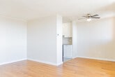 Located at 2199 Walker Ave in Peterborough, Ontario, this 2-bedroom, 1-bathroom unit offers a practical and comfortable layout across a single floor. The living area is bright and open, featuring warm-toned hardwood flooring and a large window that frames expansive views of the Peterborough skyline and surrounding landscape. Textured ceilings and clean white walls create a neutral, versatile backdrop throughout the space.

The kitchen is efficiently designed with white cabinetry extending to the ceiling for ample storage, stainless steel appliances including a refrigerator, microwave, and electric range, and a countertop with an integrated sink. Light tile flooring distinguishes the kitchen from the rest of the unit.

Both bedrooms continue the hardwood flooring and are well-sized, with the primary bedroom offering generous proportions. One bedroom features a large sliding-door closet, while both rooms benefit from baseboard heating and access to natural light. Views of the Peterborough area are visible from bedroom windows.

The bathroom is clean and functional, featuring a full bathtub with shower, a white vanity with storage, and tile flooring. A hallway connects the rooms, providing a logical and efficient flow throughout the unit.