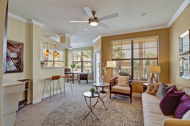 Tuscany Living Room with Floor to Ceiling Windows and Balcony - Tuscany at Faudree