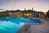 Located at 4699 Kittredge St, Unit 22-2221, in Denver, Colorado, this 810-square-foot apartment offers three bedrooms, one bathroom, and single-floor living. The unit features plush wall-to-wall carpeting throughout the bedrooms and living areas, complemented by clean white walls that create a bright, neutral palette. Large windows in the living room and bedrooms allow abundant natural light and provide outdoor views of the surrounding neighborhood and greenery. The open living area includes a kitchen with a dark-countertop peninsula, visible from the carpeted main living space. The spacious primary bedroom spans 400 square feet and is equipped with a ceiling fan and a dedicated walk-in closet featuring dual hanging rods and a central shelving unit. Two additional bedrooms also include ceiling fans and windows with neighborhood views. The full bathroom is finished with gray subway tile surrounding a soaking tub and shower, rich hardwood-style flooring, white cabinetry, and a dark countertop vanity. A dedicated in-unit laundry room houses a full-size washer and dryer with overhead shelving and hardwood-style flooring. This well-appointed apartment combines functional design with comfortable living in Denver's 80239 corridor.