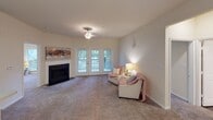 Located at 8230 Carter Creek Dr in Charlotte, NC, this single-floor residence offers a well-designed layout with a seamless flow between living, dining, and kitchen spaces. The open-concept living and dining area is anchored by a classic fireplace and features plush carpeting throughout, creating a warm and inviting atmosphere. French doors flood the living space with natural light and provide access to an outdoor area, enhancing the sense of openness. A pendant light fixture serves as a focal point above the kitchen peninsula, which connects the kitchen to the main living area.

The galley-style kitchen is equipped with white cabinetry, light countertops, black appliances including a refrigerator, electric range, and built-in microwave, as well as durable wood-look flooring. Ample cabinet storage and a stainless steel sink add to its functionality.

The bedrooms are carpeted and feature generous closet space, including a walk-in closet in one room. Both bathrooms include tub-shower combinations, wood-look flooring, and vanity sinks. The neutral, warm color palette used throughout the residence creates a cohesive and comfortable living environment, while the practical layout makes efficient use of the available space.
