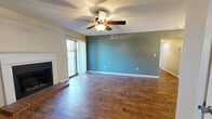 Located at 3315 N Hills St in Meridian, Mississippi, this single-floor, 2-bedroom, 2-bathroom home offers a practical and comfortable layout. The living room serves as the heart of the home, featuring rich hardwood flooring, a classic brick-hearth fireplace with a white wood mantle, and a ceiling fan with light fixture — creating a warm, inviting atmosphere. An adjacent area with wood-look flooring and a teal accent wall provides additional flexible living space.

The kitchen is well-equipped with light maple cabinetry, granite-look countertops, a stainless steel refrigerator, stainless steel dishwasher, and a double-basin sink, offering both functionality and a clean aesthetic.

Both bedrooms are carpeted for comfort and feature ceiling fans, natural light from windows with blinds, and neutral two-tone walls in soft sage and beige tones. The spacious primary bedroom provides a generous footprint with ample room for furnishings. A dedicated closet adds practical storage to the layout.

The two bathrooms are identically appointed, each offering a full tub-shower combo with a chrome curtain rod, a toilet, and clean, neutral finishes throughout. The textured ceilings carry through the entire home, adding a consistent architectural detail.