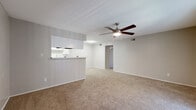 This 2-bedroom, 2-bathroom residence in Austin's vibrant 78704 neighborhood offers a functional and comfortable single-floor layout. The open-concept living room is bright and welcoming, featuring plush carpeting, a ceiling fan with light fixture, and a sliding glass door that fills the space with natural light and provides outdoor access. A half-wall pass-through connects the living area to the galley-style kitchen, which is outfitted with white cabinetry, light countertops, black appliances including a range and refrigerator, and wood-look flooring that adds warmth and contrast.

Both bedrooms are carpeted and equipped with ceiling fans. The primary bedroom offers a generous footprint and connects to a walk-in closet with wire shelving on both sides, providing ample storage. The second bedroom also features a sliding glass door with outdoor views. Each of the two bathrooms is finished with wood-look flooring, white vanity cabinetry, and a tub-shower combination, maintaining a clean and consistent aesthetic throughout. A dedicated hallway connects the private areas of the home, contributing to an efficient and well-organized floor plan suited for everyday living in Austin.