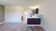 This 580-square-foot, one-bedroom, one-bathroom apartment at 1675 NW Fourth Ave, Apt 714 in Boca Raton, FL offers a clean, modern layout across a single floor. Wood-look tile flooring flows consistently throughout the unit, creating a cohesive and low-maintenance aesthetic.

The open-concept living and kitchen area forms the heart of the apartment. The kitchen is equipped with rich, dark espresso shaker cabinets — both upper and lower — paired with crisp white countertops and a subtle tile backsplash. Stainless steel appliances, including a refrigerator, complete the space. A peninsula counter extends into the living area, providing additional prep space and a casual dining option.

The primary bedroom measures a spacious 180 square feet and features a sliding mirrored closet, a window with vertical blinds that allows natural light, and direct access to the hallway. The bathroom includes a full tub-shower combination with a curtain rod, wood-look flooring, and a clean, neutral design. A hallway connects the main living areas to the bedroom and bathroom, providing a practical and organized flow throughout the unit. This apartment presents a functional and attractive living space in the heart of Boca Raton.