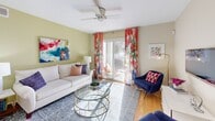 Located at 141 Nina Dr in Virginia Beach, VA, this single-floor, 2-bedroom, 2-bathroom home offers a thoughtfully designed layout that makes efficient use of its space. Warm hardwood flooring flows throughout the main living areas, creating a cohesive and inviting atmosphere.

The kitchen is a functional highlight, featuring granite-style countertops, a peninsula with bar seating, white cabinetry, stainless steel appliances, and a skylight that fills the space with natural light. An adjacent pantry and dedicated laundry area with in-unit washer add everyday convenience.

The open dining area connects seamlessly to the kitchen and is anchored by an elegant chandelier overhead, making it an ideal space for both casual meals and entertaining. The living room is bright and welcoming, with hardwood floors and a clean, neutral palette.

The primary bedroom is a comfortable retreat, featuring soft carpet, a ceiling fan, serene sage-toned accent walls, and large windows that invite natural light. The second bedroom mirrors this calm aesthetic with its own accent wall and closet. Both bathrooms are well-appointed with tub-shower combinations. A hallway and closet round out this efficiently arranged, move-in-ready home.