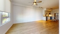 This contemporary 690 square foot apartment in Carson, CA offers a thoughtful layout maximizing space and functionality. The open-concept design seamlessly integrates the kitchen and living area, creating a spacious feel. The kitchen boasts modern white cabinetry, stainless steel appliances, and a movable kitchen island, perfect for meal prep or casual dining.

The living area features warm wood flooring and is illuminated by both recessed lighting and a stylish ceiling fan. Large windows flood the space with natural light, enhancing the airy ambiance. The primary bedroom, measuring 160 square feet, includes plush carpeting and a sizable window with a view.

Throughout the apartment, clean white walls provide a neutral backdrop, allowing for personalized décor. The second bedroom offers versatility as a guest room or home office. Ceiling fans in both the living area and bedrooms ensure comfort year-round.

This well-designed apartment combines modern aesthetics with practical living, ideal for those seeking a contemporary urban lifestyle in a compact yet efficient space.